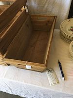 Photo of the empty rectangular wooden crate showing the interior and construction details.