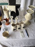 Full lot of various Lenox vases, candlesticks, and containers arranged on a white cloth