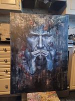 Full view of the painting leaning against kitchen cabinets showing size and frame details