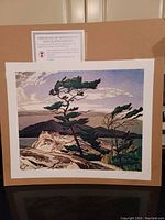 Full view of the unframed AJ Casson fine art print titled "White Pine," showing the tree and surrounding rocky landscape with certificate of authenticity attached.