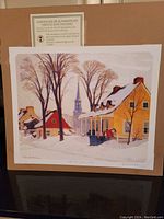 Unframed fine art print titled 'Winter Morning Baie St Paul' by Clarance Gagnon showing a winter village scene with snow, houses, and church steeple.