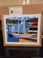 Full image of the Maud Lewis lithograph print on board with information card behind it.