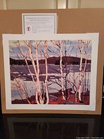 Full view of unframed print mounted on backing with certificate overhead