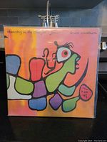 Front cover of the LP showing the colorful Norval Morrisseau inspired artwork with an abstract figure and bold black outlines.