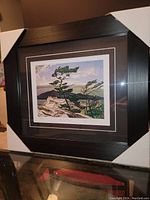 Full photo of framed AJ Casson print with protective cardboard on corners.