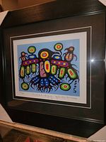 Framed colorful fine art print showing the entire enclosed artwork and frame, with signature and numbering on print visible.