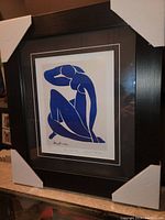 Front view of framed print with cardboard corner protectors in place