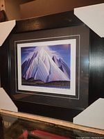 Framed Lawren Harris print with corner guards, side view showing the frame depth and matting.