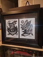 Framed art piece containing two black and white Tim Tait prints, showing both prints in the frame.