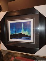 Framed fine art print showing Northern Lights image with black frame and double mats