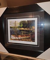 Framed fine art print showing full frame with the print centered inside with matting and dark wood frame with corner protectors.