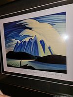 Close-up of the art print showing the stylized mountains and lake with swirling clouds, signed and titled by Lawren Harris.