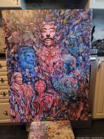 Front view of the large acrylic painting showing the full canvas with a complex, colorful composition of faces and animals.