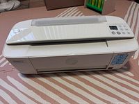 HP DeskJet 3752 printer top and front view showing overall condition and control panel with buttons and display.