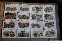 Photo of 16 stock cards laid out showing various postage stamps from Netherlands and Caribbean countries