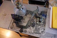 Cast iron bracket with ornate design and bronze finish showing patina and weight.