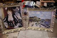 Two old Renoir art prints in ornate silver-tone metal frames with scroll and floral detailing, placed next to each other showing front view.