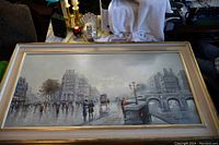 Full view of framed oil painting showing cityscape scene