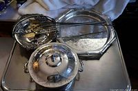Photo showing large oval tray, covered serving dish, small pierced basket, Victorian handled serving dish, and four long-handled forks