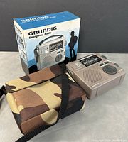 Photo of Grundig FR-200 emergency radio with original box and camouflage carry case