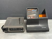 Polaroid Spectra System instant camera with controls visible on the side, in very good condition with minor wear.