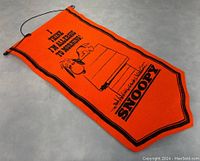 Banner laid flat on floor showing full design and shape.