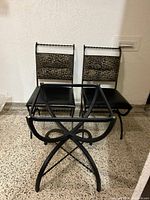 Three photos showing wrought iron dining table frame and four chairs. Glass top not displayed.