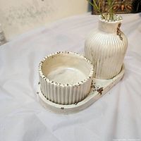 Top angled view of flower pot and jewelry box on the tray showing distressed finish and ribbed ceramic texture