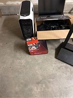 Overview of white PC tower, small PC, monitor box, Star Wars and AMD boxes