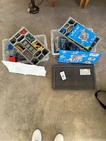 Overview of multiple organizers and storage boxes containing assorted VEX IQ robotics building components.