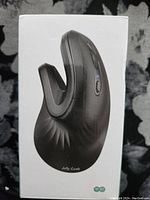 Photo showing the side view of the black Jelly Comb wireless vertical ergonomic mouse with thumb rest and control buttons.
