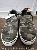 Front view of new men's camo slip-on shoes size 10