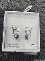 Photo of sterling silver cubic zirconia earrings in display box showing the price and material information.
