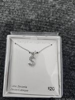 Sterling silver necklace with cubic zirconia 'S' pendant in a presentation box showing the price $20