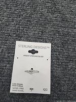Sterling silver ring on branded Sterling Designs card with cubic zirconia stone, size 7, nickel free.