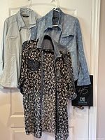 Three tops hanging on a door: light denim-look shirt (Tahari), floral and denim mix top (Mono Dot), dark floral embellished top (Streetwear Society).