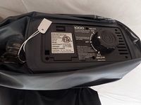 Close-up of the IDOO built-in electric pump and control dial with safety labels visible.