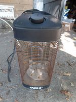 Front angle view showing the cylindrical electric heater with rusted grill and visible heating element inside.