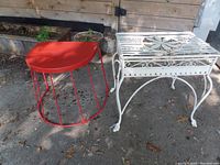 Image showing both tables outdoors: off-white metal table with decorative design, and orange Ikea outdoor table with wireframe base.