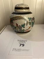 Side view of antique Chinese ginger jar showing crackle glaze and detailed multicolor bird and floral decorations