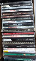 Vertical stack of CDs showing Thelonious Monk, Steve Earle, Miles Davis, Thin Lizzy, Herbie Hancock