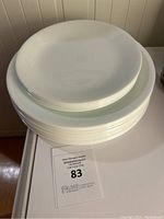Stack of 21 white Corelle plates including large and medium sizes