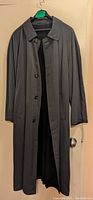 Front view of the dark grey men's long coat by Hugo Boss with open buttons showing wool lining.