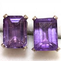 Front view of a pair of rectangular faceted amethyst stones in silver prong settings as stud earrings.