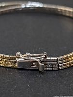 Close-up of the box clasp with safety latch showing the intricate locking mechanism and silver finish of the bracelet.