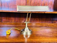 Front view of the vintage brass bankers lamp illustrating overall condition and style.