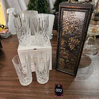 Four lead crystal highball glasses placed on and around their original white box, showing the 24% lead crystal mark.