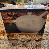 Box showing the brand Sussex and product name Saucier Salsera, image of white oval ceramic gravy tureen with lid and ladle on box front.