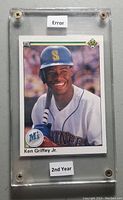 Front of Ken Griffey Jr. 1990 Upper Deck baseball card showing player in Mariners uniform holding a bat inside protective hard plastic case with 'Error' and '2nd Year' labels.