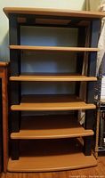 Front view of the Atlantis audio rack showing metal frame and wood shelves.
